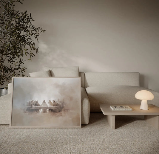 Last Supper Jesus and disciples misty watercolor beige art print in a natural wood float frame leaning against a linen sofa in a calm neutral living room – JesusArtworks