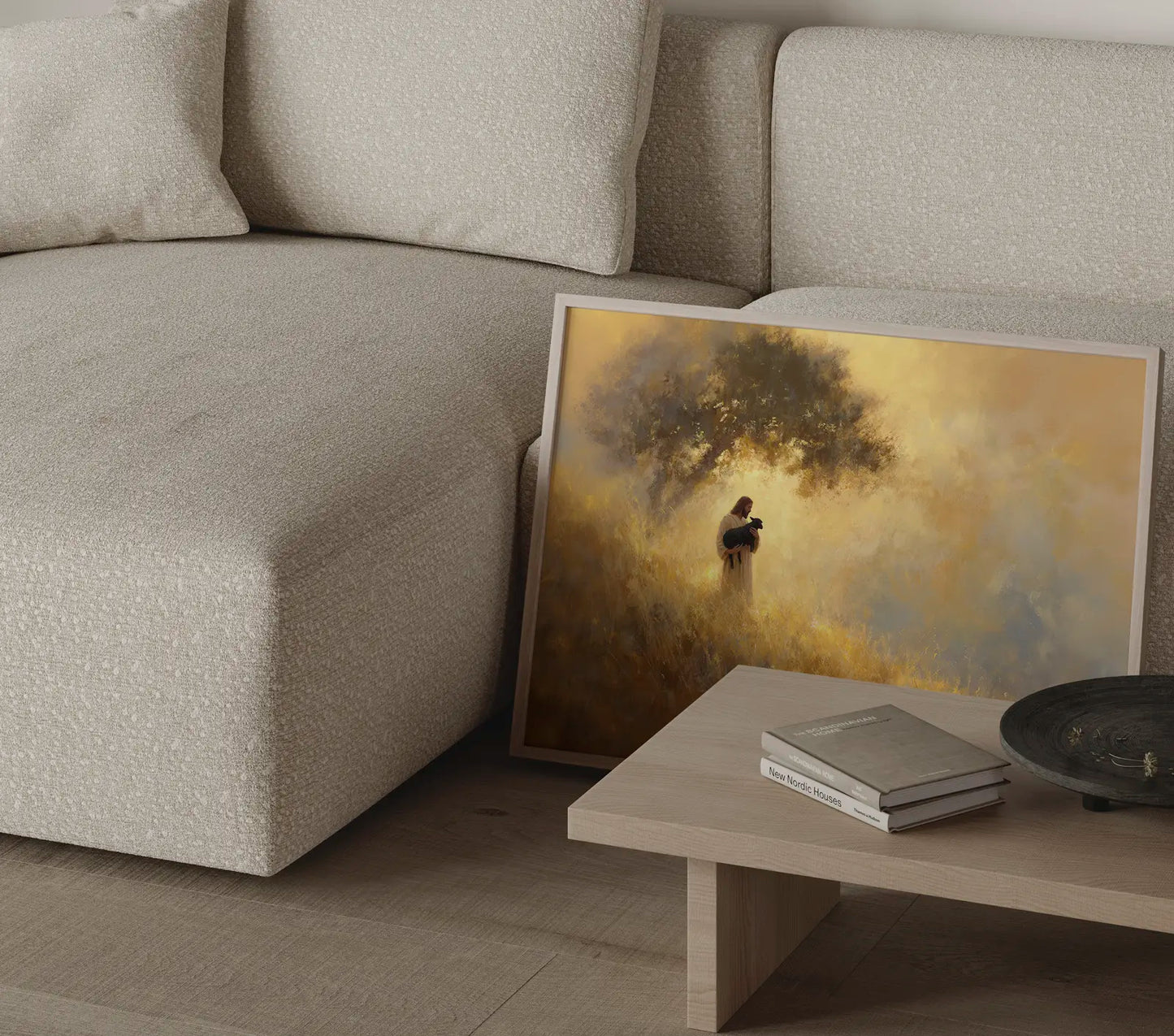 Good Shepherd art print with Jesus cradling a black lamb in a sunlit meadow styled in a contemporary Scandinavian interior