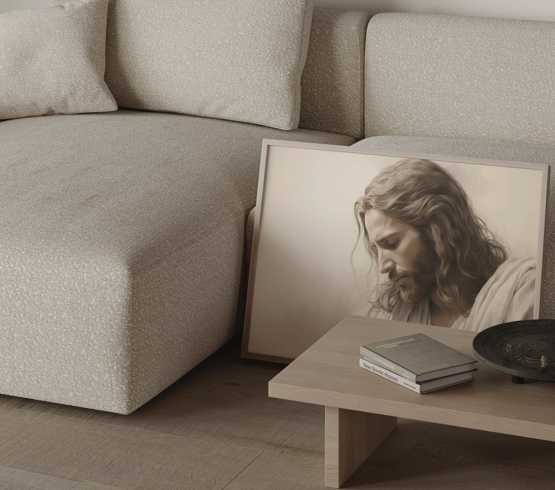 Contemplative Jesus wall art print leaning against a cream sofa — modern Christian home decor