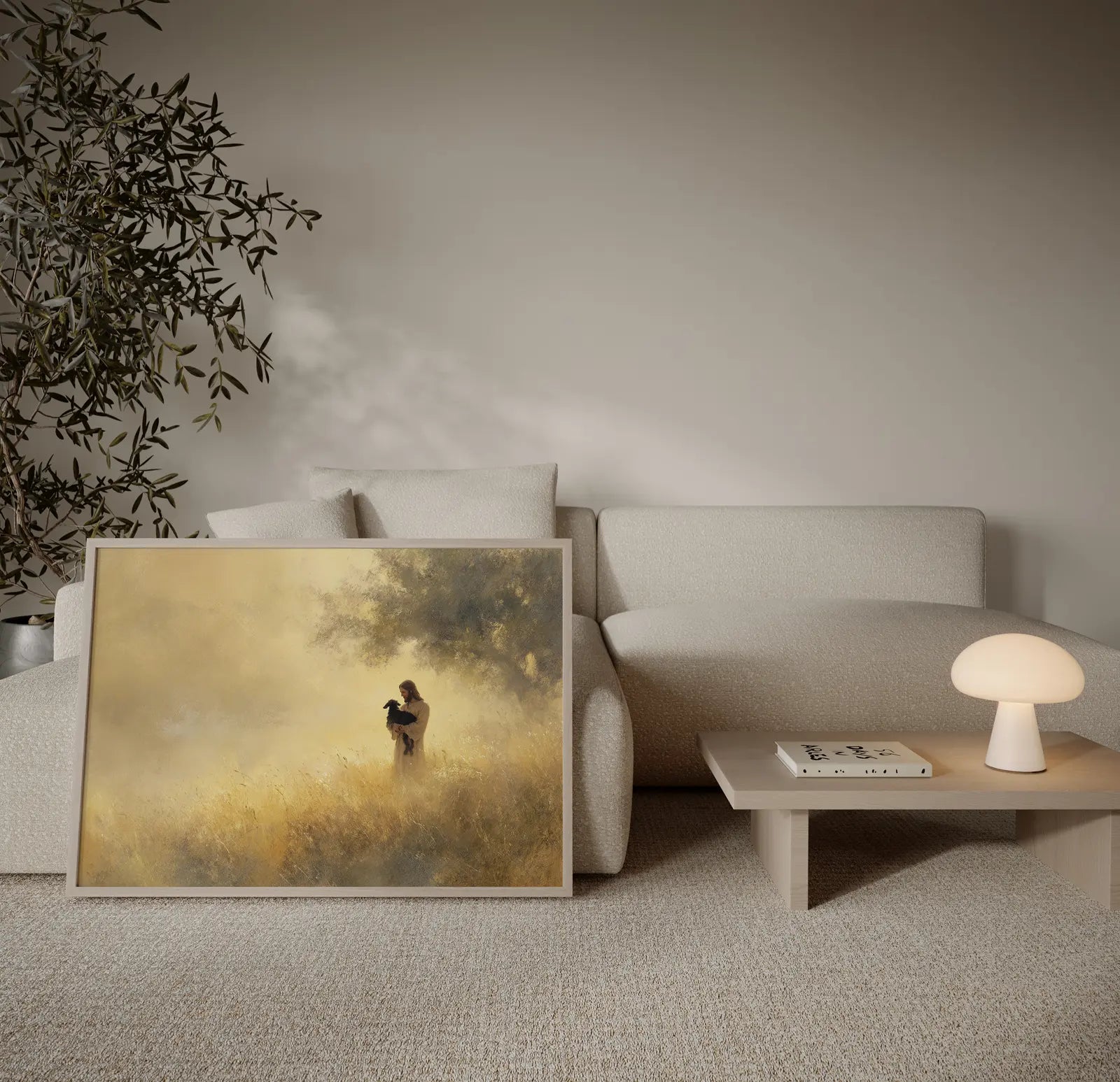 Minimalist Jesus and black lamb painting in warm golden tones, framed and leaning beside a cream couch in a modern home