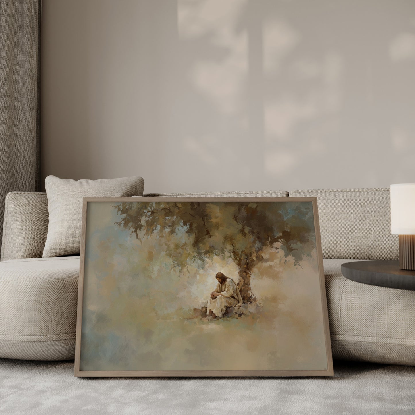 Christian artwork showing Jesus meditating under a tree, rendered in a tonal, impressionist style with gentle light filtering through leaves.