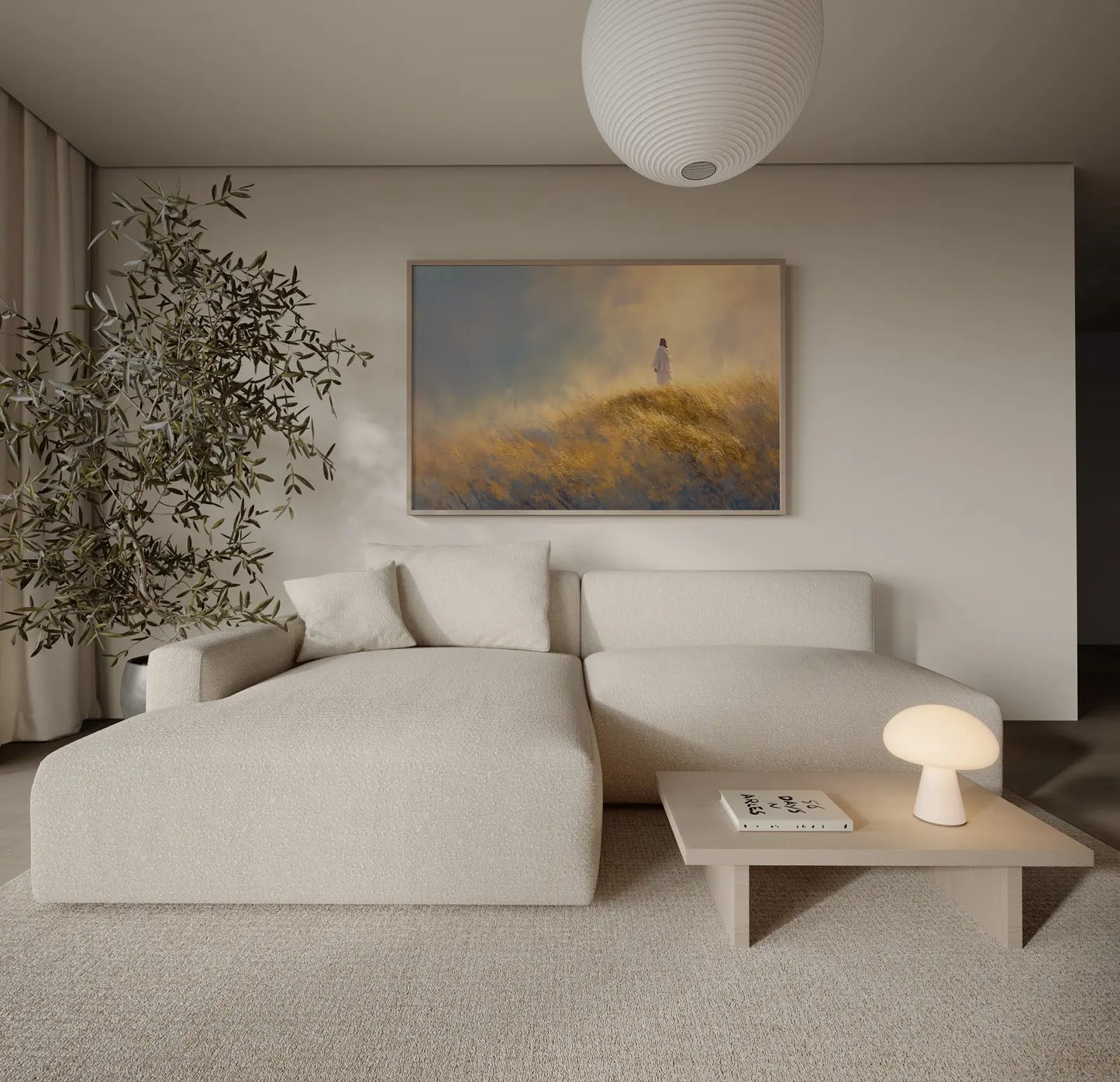 Minimalist Christian landscape painting of Jesus walking a golden ridge, framed and leaning beside a cream couch in a modern home