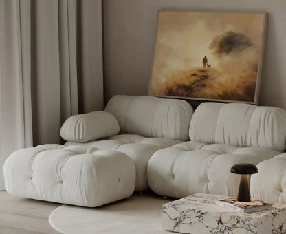 Psalm 23 inspired painting of Jesus walking alongside a lamb in warm golden mist, framed and leaning beside a cream couch