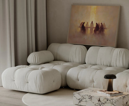 Golden-toned panoramic Last Supper painting in a thin frame leaning against a cream couch – JesusArtworks