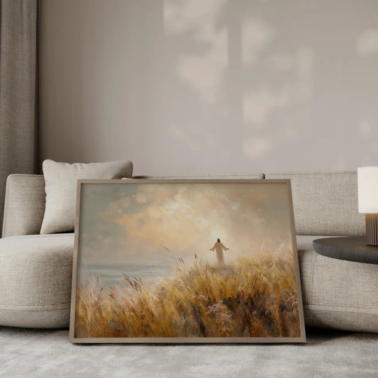 The Blessing Jesus with open arms wall art print in a gold frame leaning against a modern beige sofa – Christian home decor by JesusArtworks