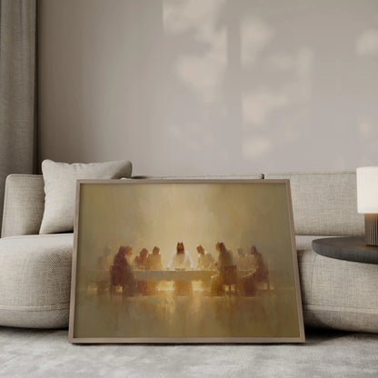 The Sacred Gathering Last Supper wall art print in a gold frame leaning against a modern beige sofa – Christian home decor by JesusArtworks