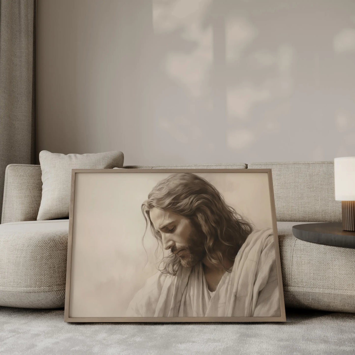 The Humble King contemplative Jesus portrait wall art leaning against a sofa in a modern minimalist living room