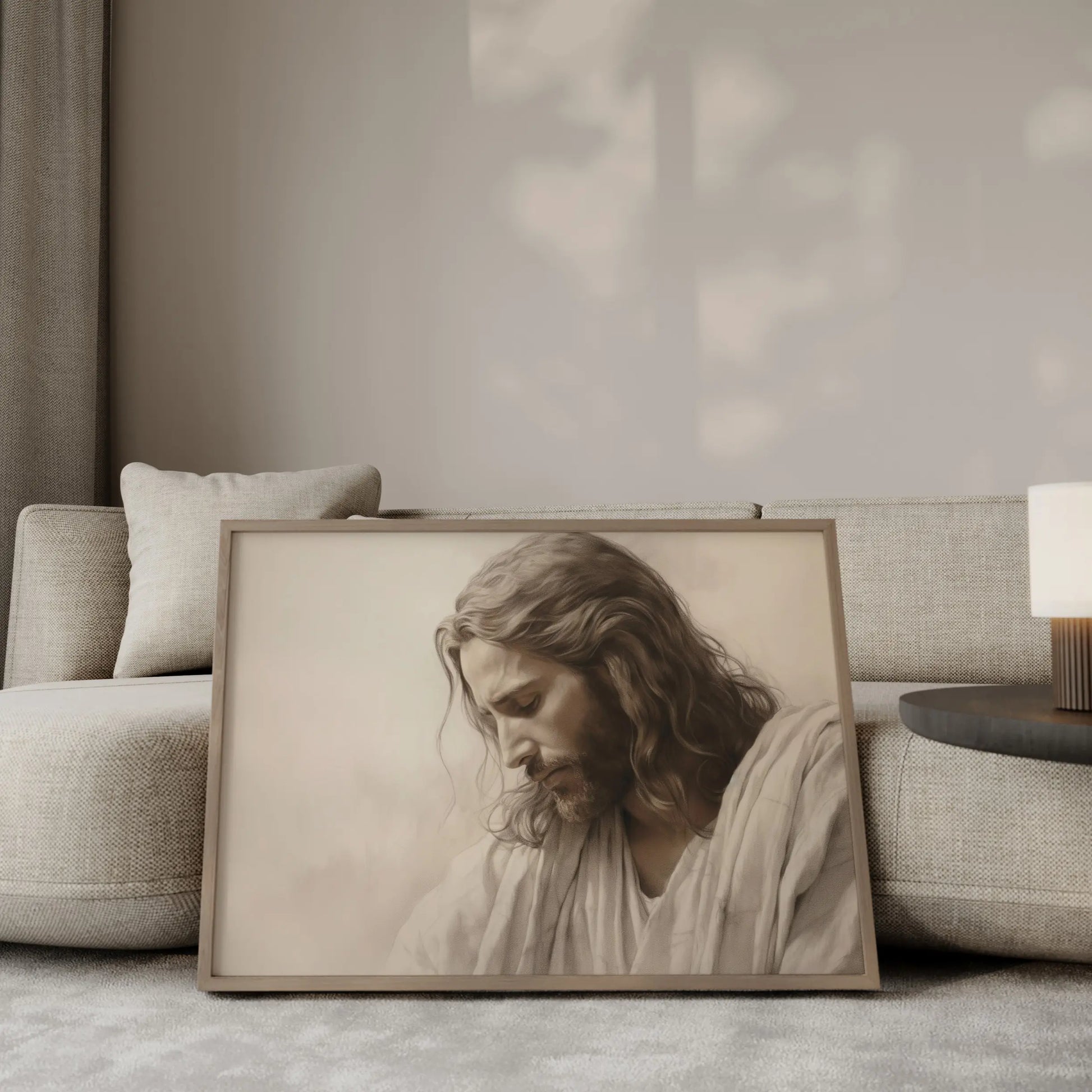 The Humble King contemplative Jesus portrait wall art leaning against a sofa in a modern minimalist living room