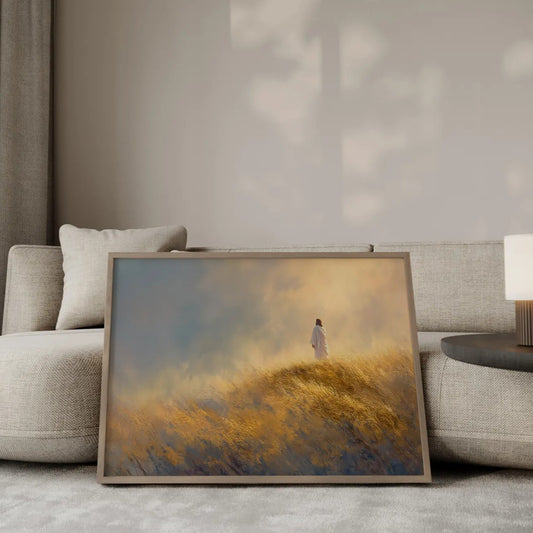 The Narrow Path Jesus walking on a hillside wall art print in a gold frame leaning against a modern beige sofa – Christian home decor by JesusArtworks