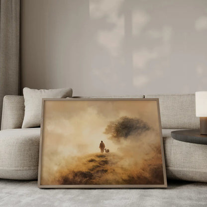The Shepherd's Path Jesus walking with a lamb wall art print in a gold frame leaning against a modern beige sofa – Christian home decor by JesusArtworks